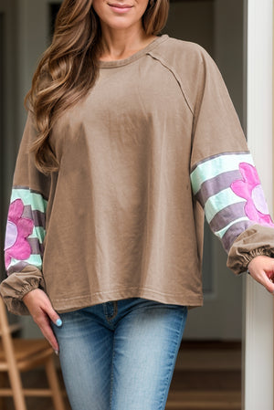 Camel raglan sleeve top with floral appliqué and striped sleeves