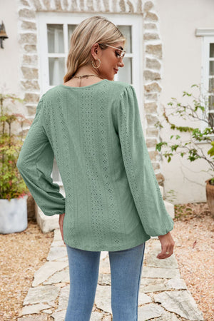 Light green eyelet yoke blouse with blouson sleeves and a textured pattern.