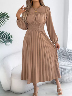 Khaki midi dress with ruffled neckline, smocked waist, and pleated skirt.