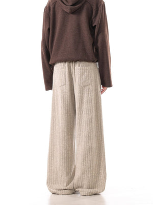 Khaki ribbed sweatpants with wide legs and back pockets.