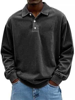 Men's vintage washed long sleeve polo shirt in dark grey cotton with buttoned placket.