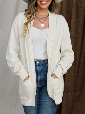 White textured knit open-front cardigan with pockets and ribbed trim.