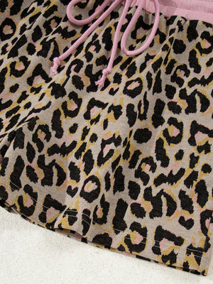 Loungewear shorts with leopard print, pink drawstring, and pink waistband.