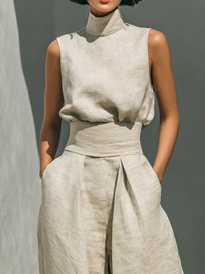 Sleeveless mock-neck ivory top and wide-leg pants set with belted waist and pleats