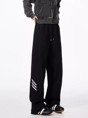 Black relaxed fit sweatpants with drawstring and white stripe detail on leg