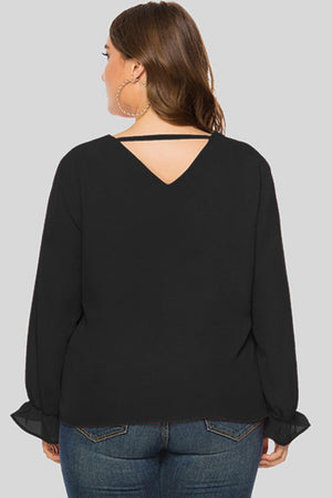 Black V-neck blouse with long sleeves and cutout detail at back neckline.