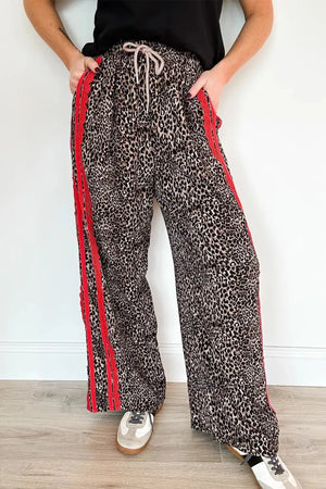 Chic leopard print wide-leg maternity pants with red stripe detail and drawstring waist.