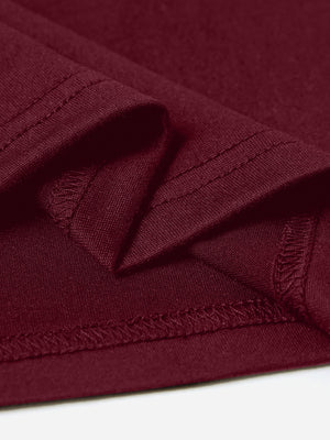 Burgundy maternity t-shirt detail showing hem and stitching.