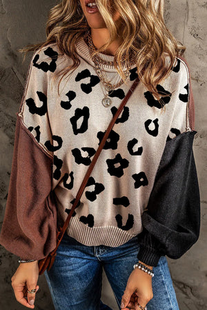 Colorblock leopard print knit sweater with contrast sleeves and crew neck.
