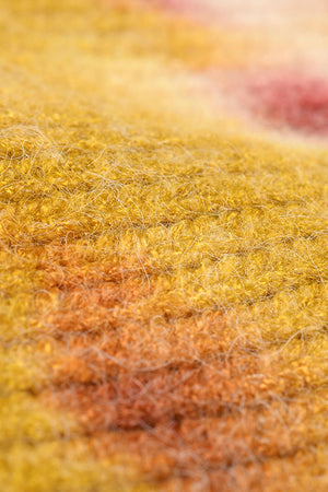 Ribbed knit beanie with sunset dip-dye gradient in yellow, orange, and pink hues.