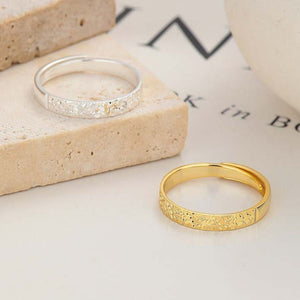 Textured sterling silver and gold adjustable rings with intricate patterns.