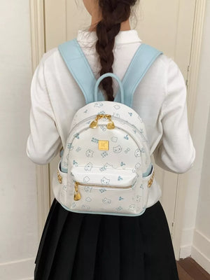 Playful mini backpack with cat print and light blue straps, gold hardware.