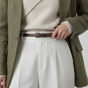 Brown cowhide leather belt with silver buckle, styled with white trousers and a blazer.