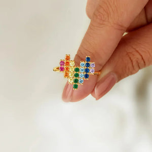 Gold ring with pixel heart rainbow design made of colorful cubic zirconia stones.