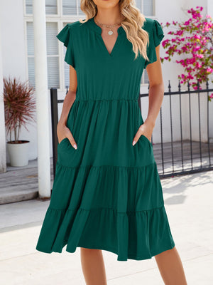 Dark green ruffled midi dress with notched V-neck and flutter sleeves, featuring tiered skirt and pockets.