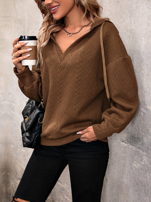 Chestnut cable knit hooded pullover with textured diamond pattern and v-neck.