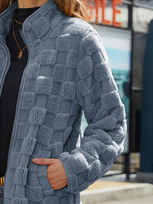 Textured grid zip-up jacket in grey fleece with a mock neck and side pockets.
