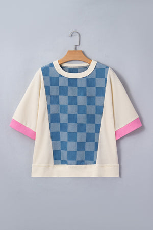 Maternity t-shirt with blue checkered denim panel, cream waffle knit, and pink sleeve cuffs.