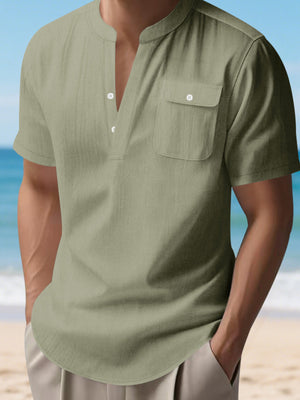 Military green cotton short sleeve henley shirt with band collar and chest pocket.