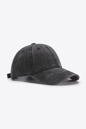 Washed cotton baseball cap in black with adjustable strap and curved brim.