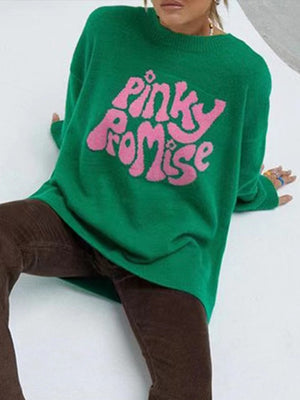 Green knit sweater with pink "Pinky Promise" graphic.