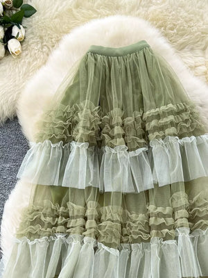 Green tiered tulle skirt with ruffled tiers and a midi length.