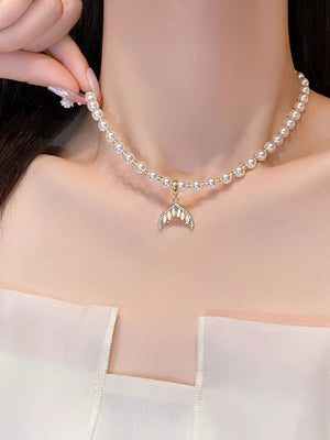 Pearl choker necklace with gold mermaid tail pendant and clear crystals