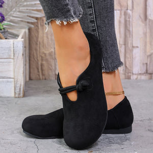 Black matte fabric round toe flats with cord detail and cut-out strap.