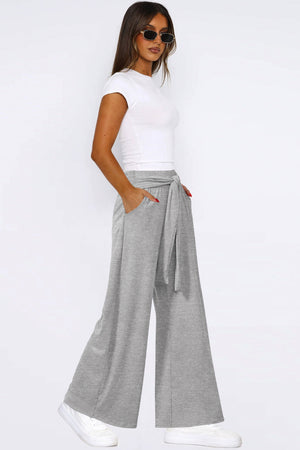 Light gray soft drape palazzo trousers with tie waist and wide legs.