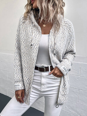 Textured knit zip-up cardigan in a herringbone pattern with a drawstring hood and logo detail on the sleeve.