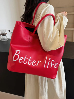 Red tote bag with white Better Life graphic and red handles.