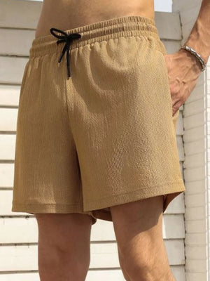 Men's khaki chino shorts with drawstring waist and textured fabric.