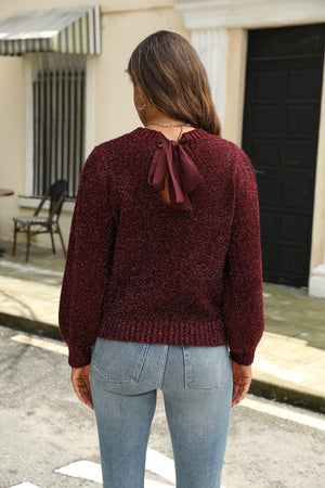 Burgundy bouclé knit sweater with back bow detail and long sleeves.