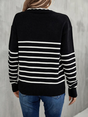 Black and white striped knit sweater with scalloped trim neckline and ribbed cuffs.