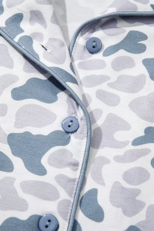 Camouflage print button-down pajama top with blue piping and buttons.