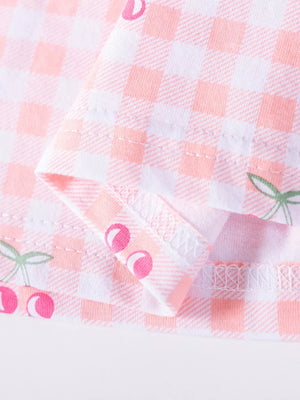 Baby dress with pink gingham and cherry embroidery.