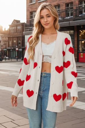 Beige knit cardigan with red heart appliqués, button front, long sleeves