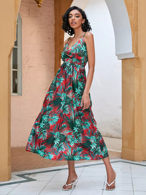 Chic floral midi dress with spaghetti straps in red and green tropical print.