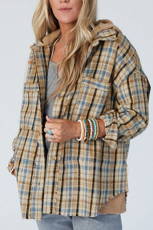 Textured plaid hooded overshirt with raw hem and cozy knit details.