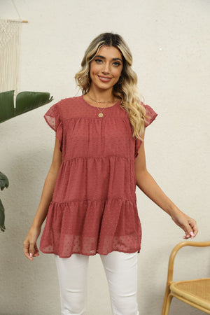 Swiss dot tiered flutter sleeve blouse in Brick Red with round neckline.