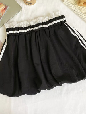 Black mini skirt with gathered waist, white lace trim, and side stripes.