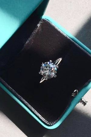 Silver ring with brilliant cut moissanite in a velvet box