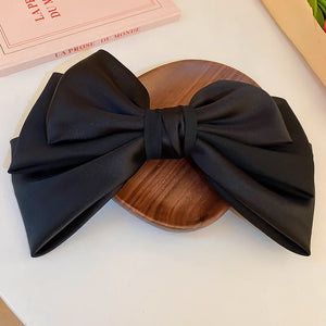 Black satin bow barrette hair clip with large bow detail