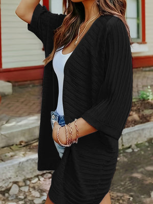 Black ribbed sleeve cardigan with open front and textured fabric.