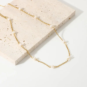 Delicate gold chain necklace with scattered pearls