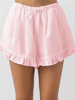 Blush pink ruffled shorts with drawstring waist and elastic waistband