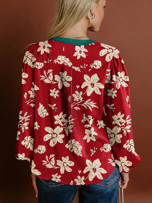 Red floral print blouse with long sleeves and a green collar detail.