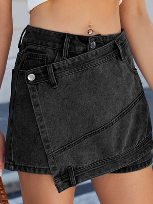 Black denim skort with wrap-effect front and angled seams.