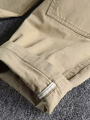 Khaki cargo pants with elastic waist and cuffed hem detail.