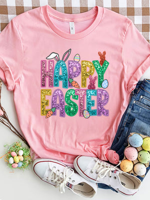 Pink t-shirt with glitter Happy Easter graphic featuring bunnies, carrots, and eggs.